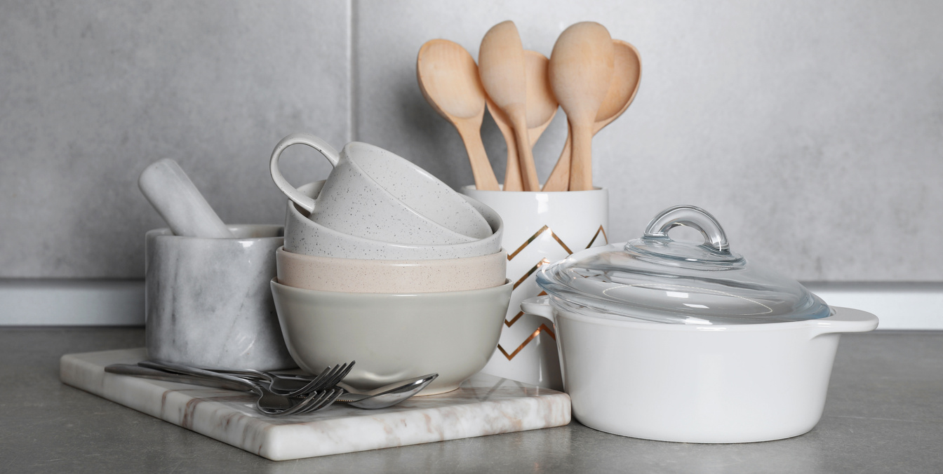 Set of Cooking Utensils and Cookware on Grey Countertop in Kitchen. Banner Design