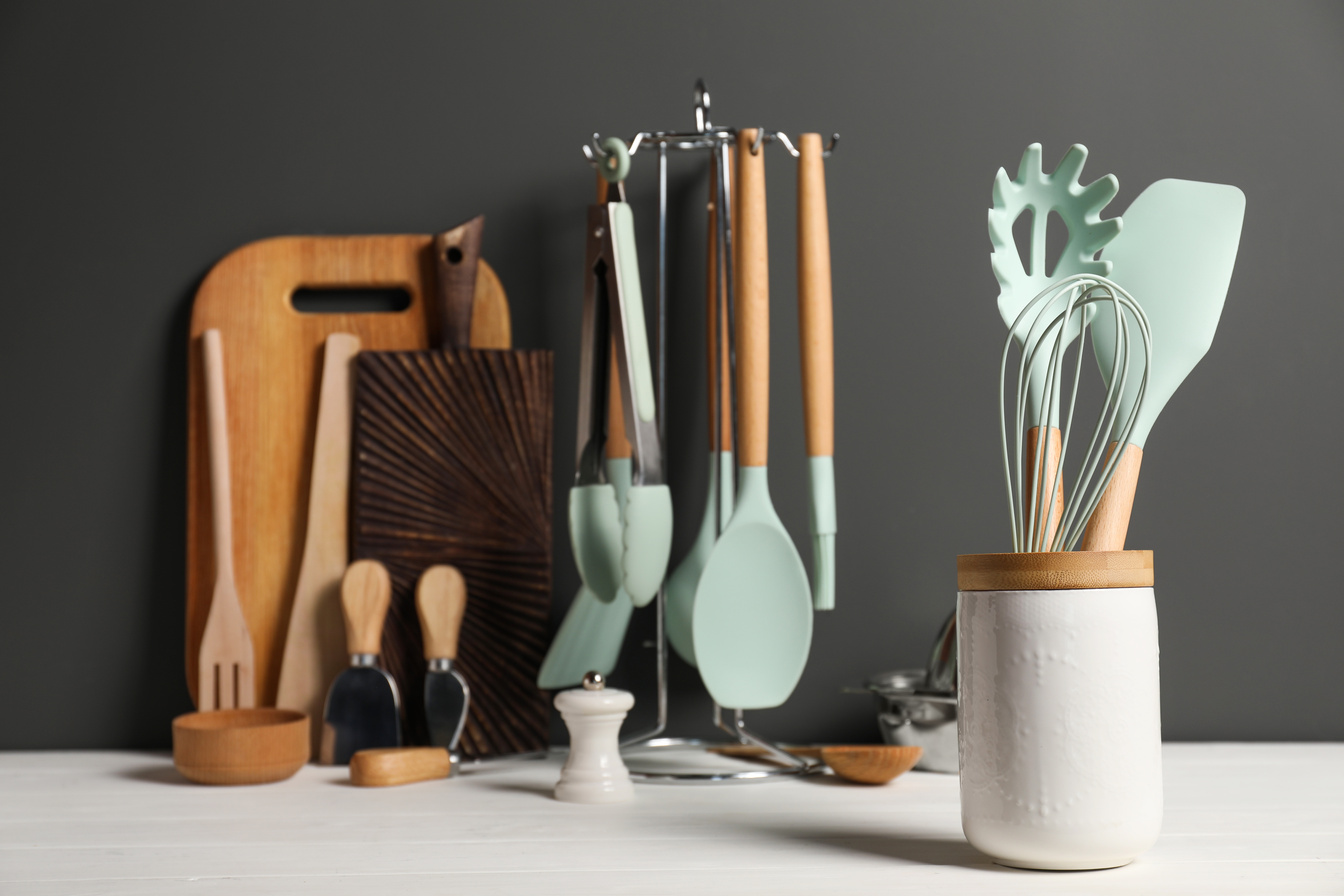 Set of Different Kitchen Utensils on White Wooden Table against